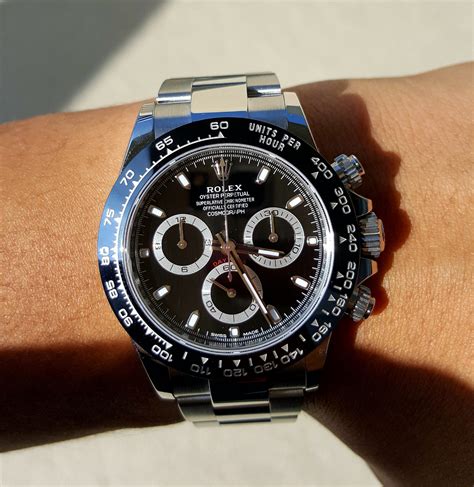 silver rolex with black face.